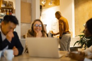 Business team watching something on laptop in cafe
